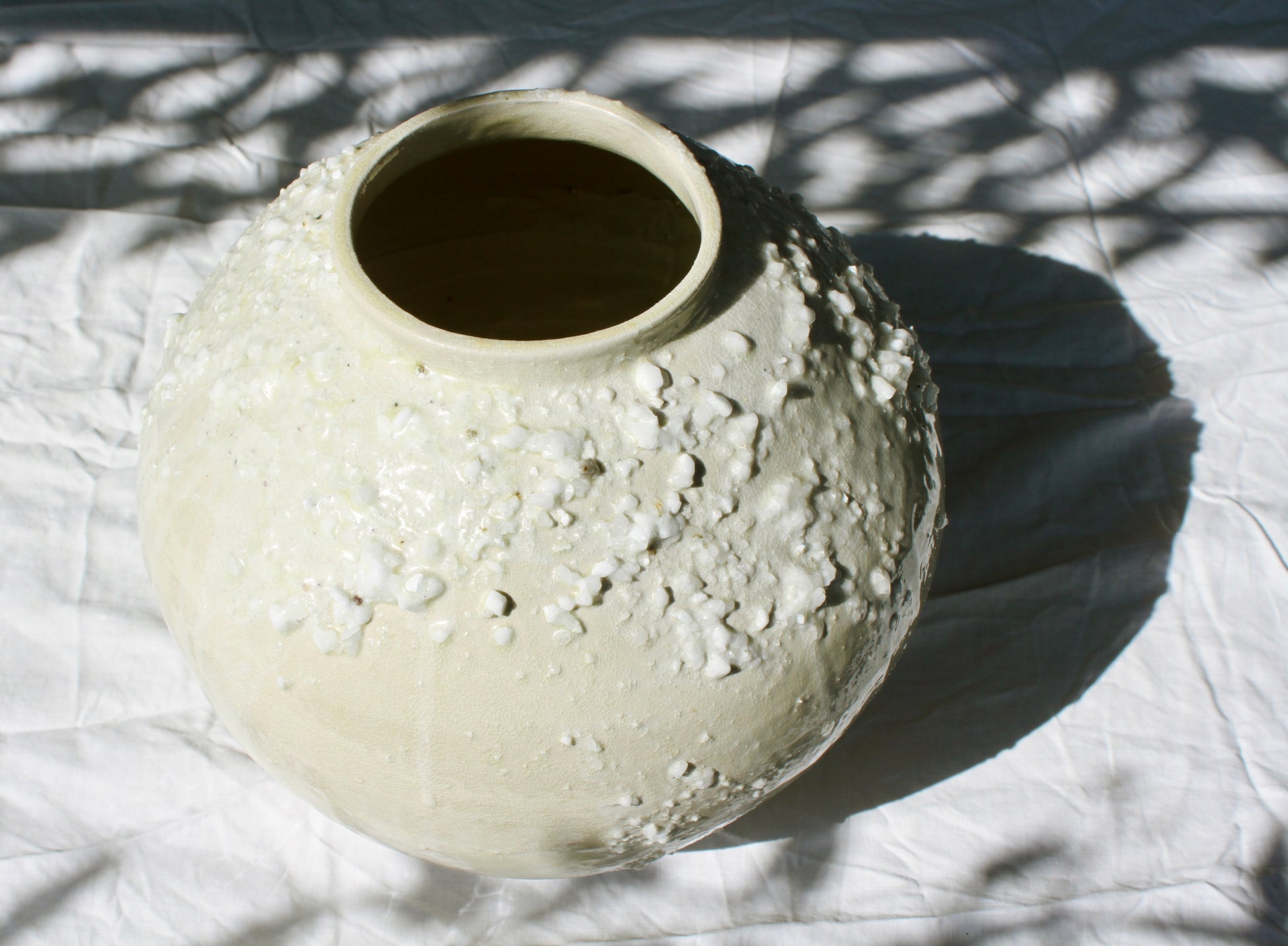 <p>Wheel thrown and altered, this moon jar was created in the traditional way, joining two pieces in the middle.</p> <p>The large moon jar is made from white Australian stoneware, decorated with transparent glaze and quartz-like feldspar chips that catch the light, so as to experiment with purity of form.&nbsp;&nbsp;</p> <p>Reduction fired.&nbsp;</p> <p>One of a kind.&nbsp;</p>